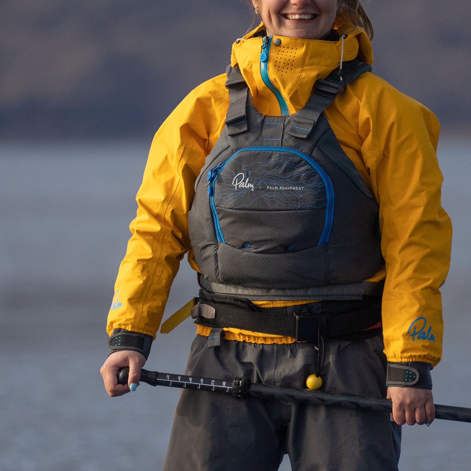 Female Paddler on a SUP in a jet grey palm riff and gold palm chinook