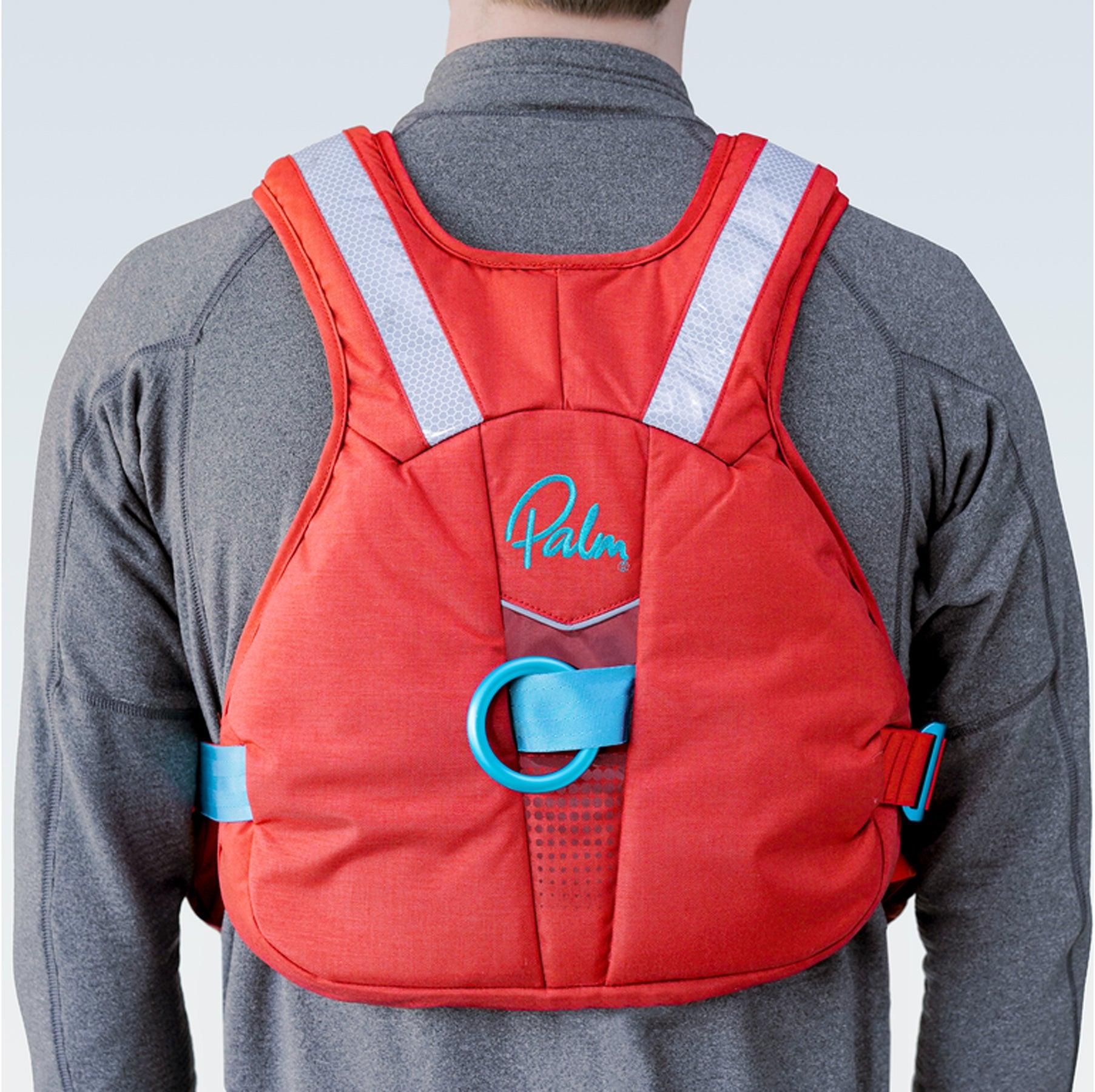 The rear of a Palm Nevis Buoyancy aid showing the reflective strips and quick release belt/loop